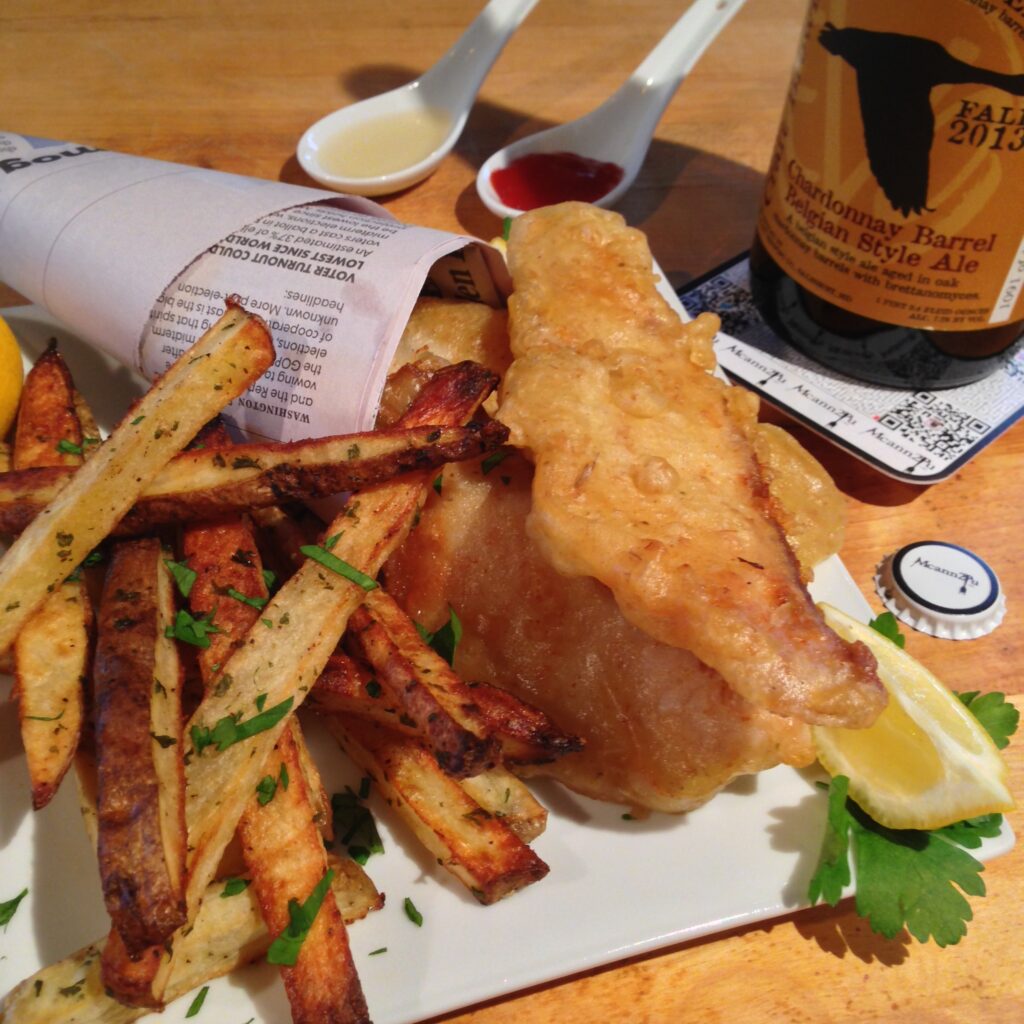 Beer battered fish and chips served in a newspaper cone with home baked potato “fries”.