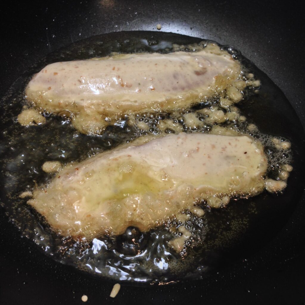 Frying beer battered fish for fish and chips.
